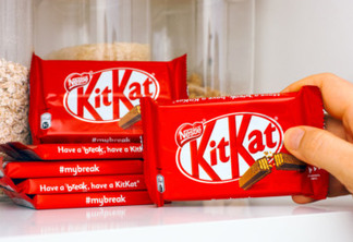 Tambov, Russian Federation – March 19, 2021 Woman hand taking KitKat chocolate bar by Nestle from shelf of kitchen cupboard