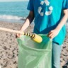 Pessoa catando lixo na praia