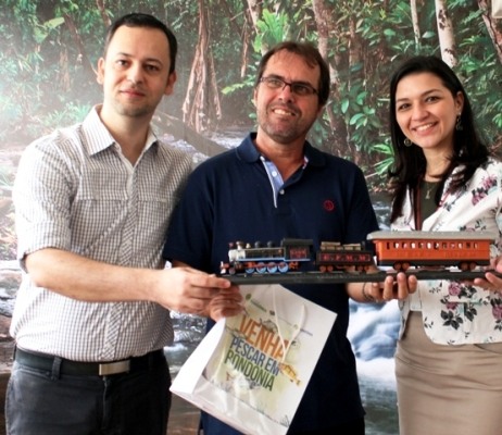 Representantes do Condohotel são presenteados com uma miniatura da locomotiva da Estrada de Ferro. (Foto: Divulgação).